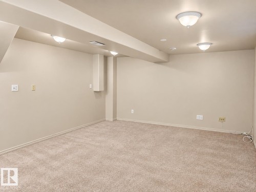 Spacious carpeted room featuring recessed lighting and flush-mount ceiling fixtures - 507 Wiseman Lane Nw, Edmonton, AB 