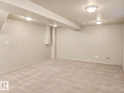 Spacious carpeted room featuring recessed lighting and flush-mount ceiling fixtures - 