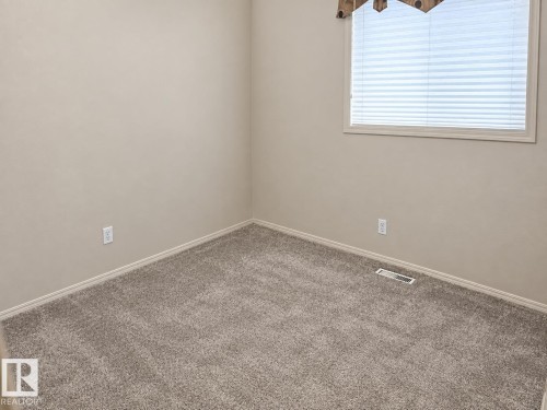 Neutral-toned walls complement the gray carpeting - 507 Wiseman Lane Nw, Edmonton, AB 