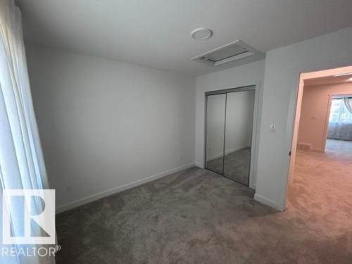 Plush carpeting, mirrored closet doors, and recessed ceiling lighting - 20936 16 Avenue Nw, Edmonton, AB - Indoor Photo Showing Other Room