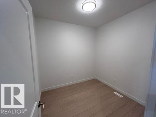 Recessed lighting, light wood-finish flooring, and crisp white walls - 20936 16 Avenue Nw, Edmonton, AB - Indoor Photo Showing Other Room