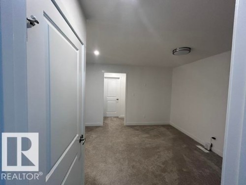 Neutral wall finishes, recessed lighting, flush-mount ceiling light, and carpeted flooring - 20936 16 Avenue Nw, Edmonton, AB - Indoor Photo Showing Other Room