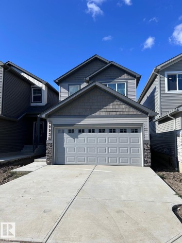 Two-story exterior with multi-toned siding, stone accents, and a front-facing garage - 20936 16 Avenue Nw, Edmonton, AB - Outdoor