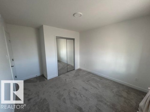 Recessed ceiling light, mirrored closet doors, and carpet flooring - 20936 16 Avenue Nw, Edmonton, AB - Indoor Photo Showing Other Room