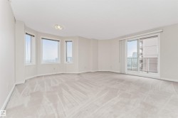 Expansive room with neutral carpeting, multiple windows providing natural light, and a sliding glass door leading to a balcony - 