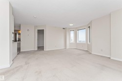 Open-concept living area with light-colored carpeting - 