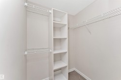 Walk-in closet featuring built-in shelving units and wire rack storage - 