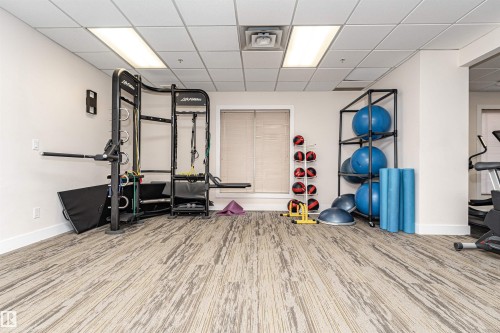 Dedicated fitness space with patterned carpeting and flush-mounted ceiling lights - #1101 10909 103 Av Nw, Edmonton, AB - Indoor Photo Showing Gym Room