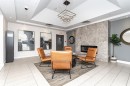 Modern lobby featuring polished light-finish flooring, coffered ceiling with recessed lighting, and a neutral color palette - #1101 10909 103 Av Nw, Edmonton, AB  - Indoor With Fireplace 