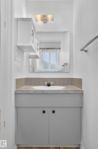 Vanity with an integrated sink, gray cabinet, and a complementing countertop - 13903 87 Street Nw, Edmonton, AB - Indoor Photo Showing Bathroom