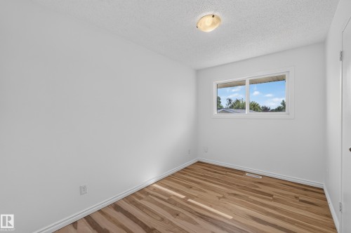 Wood-finish flooring, white walls, and a single window with white trim - 13903 87 Street Nw, Edmonton, AB - Indoor Photo Showing Other Room