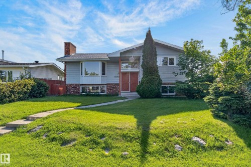 Split-level exterior featuring a brick chimney, bay window, and double entry doors - 13903 87 Street Nw, Edmonton, AB - Outdoor