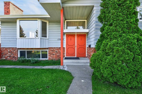 Grey siding exterior with a brick foundation and a prominent bay window - 13903 87 Street Nw, Edmonton, AB - Outdoor