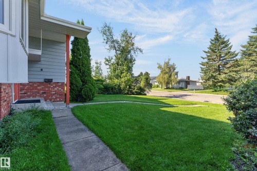 Concrete walkway leading to a front entry with a red brick facade and light blue siding - 13903 87 Street Nw, Edmonton, AB - Outdoor