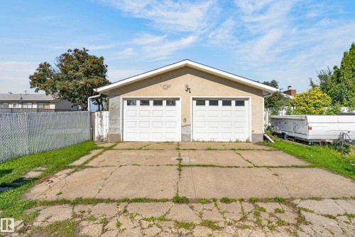 Detached two-car garage with white panel doors and upper window inserts - 13903 87 Street Nw, Edmonton, AB - Outdoor
