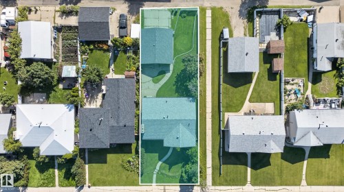 Expansive property featuring two distinct structures, a large manicured lawn, and a paved tennis court - 13903 87 Street Nw, Edmonton, AB -  With View