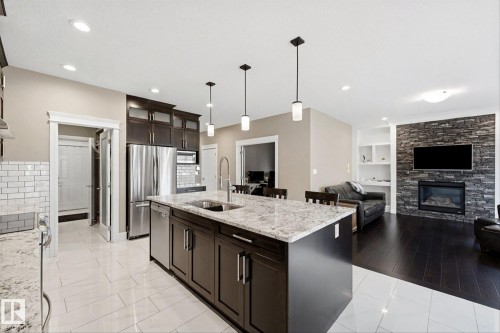 182 Woodhill Lane, Fort Saskatchewan, AB - Indoor Photo Showing Kitchen With Fireplace With Double Sink With Upgraded Kitchen