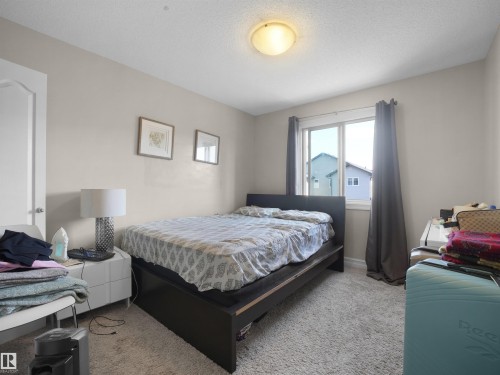Carpeted flooring, white interior door with silver hardware, light-toned walls, and a ceiling-mounted light fixture - 17127 126 Street Nw, Edmonton, AB - Indoor Photo Showing Bedroom