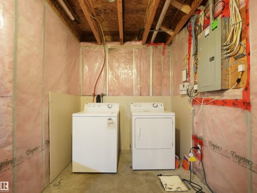 Dedicated laundry area featuring a white washing machine and a white dryer - 17127 126 Street Nw, Edmonton, AB - Indoor Photo Showing Laundry Room