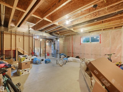 Unfinished basement with exposed ceiling joists, concrete flooring, and a single window - 17127 126 Street Nw, Edmonton, AB - Indoor Photo Showing Basement