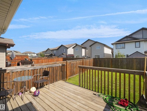 Expansive wood deck with a full wood privacy fence and a manicured lawn - 17127 126 Street Nw, Edmonton, AB - Outdoor With Deck Patio Veranda With Exterior