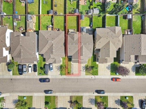 Aerial perspective highlighting a residential property with a shingled roof, a paved driveway, and a grass lawn - 17127 126 Street Nw, Edmonton, AB - 