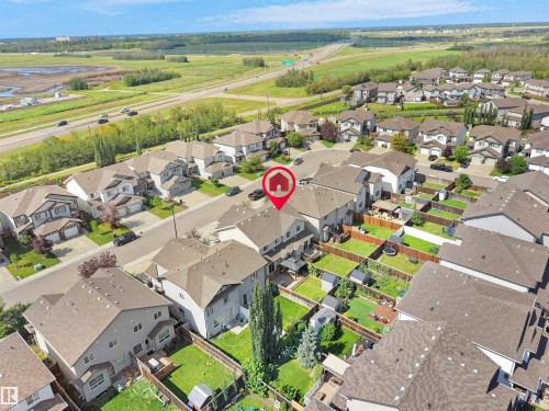 Aerial perspective of a developed residential neighborhood featuring detached homes with shingled roofs and private backyards - 17127 126 Street Nw, Edmonton, AB - Outdoor With View