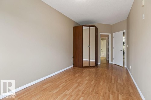 Wood-finish flooring throughout - #205 4304 139 Av Nw, Edmonton, AB - Indoor Photo Showing Other Room