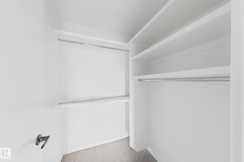 White wall-to-wall carpeting, white shelving, and hanging rods - 13118 186 Avenue Nw, Edmonton, AB - Indoor