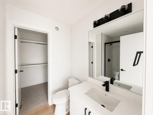 Modern bathroom featuring a floating vanity with rectangular vessel sink, quartz countertop, and matte black wall-mounted faucet - 13118 186 Avenue Nw, Edmonton, AB - Indoor Photo Showing Bathroom