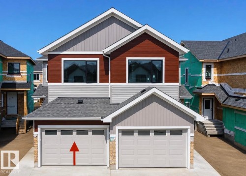 Modern exterior featuring multiple gable roofs, mixed siding materials, dark-framed windows, and an attached two-car garage - 13118 186 Avenue Nw, Edmonton, AB - Outdoor