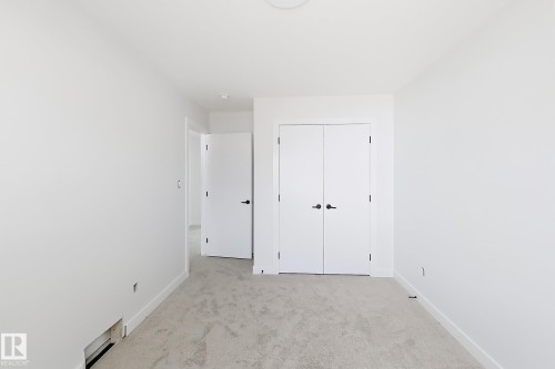 Neutral color palette with light-toned carpeting and bright white walls - 13118 186 Avenue Nw, Edmonton, AB - Indoor Photo Showing Other Room