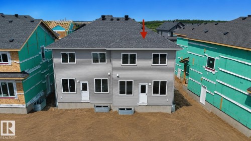 Newly constructed multi-level residence with gray horizontal siding and a dark shingled roof - 13118 186 Avenue Nw, Edmonton, AB - Outdoor