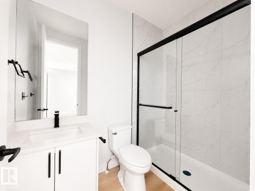 White vanity with a single basin, black matte faucet, and black hardware - 13118 186 Avenue Nw, Edmonton, AB - Indoor Photo Showing Bathroom