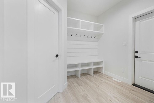 Built-in mudroom storage with integrated bench seating, shelving, and coat hooks - 9331 181 Avenue Nw, Edmonton, AB - Indoor Photo Showing Other Room