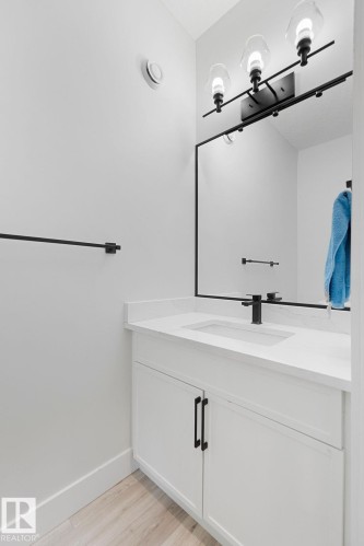 White vanity with black hardware, integrated sink, and white countertop - 9331 181 Avenue Nw, Edmonton, AB - Indoor