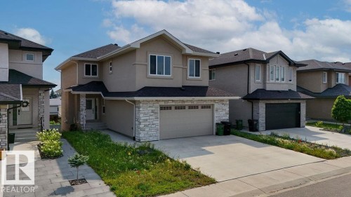 Contemporary two-story residence with a stucco and stone facade, featuring a two-car garage and a paved driveway - 9331 181 Avenue Nw, Edmonton, AB - Outdoor With Facade