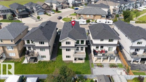 Two-story residential structure featuring multiple balconies and a dark shingle roof - 9331 181 Avenue Nw, Edmonton, AB - Outdoor