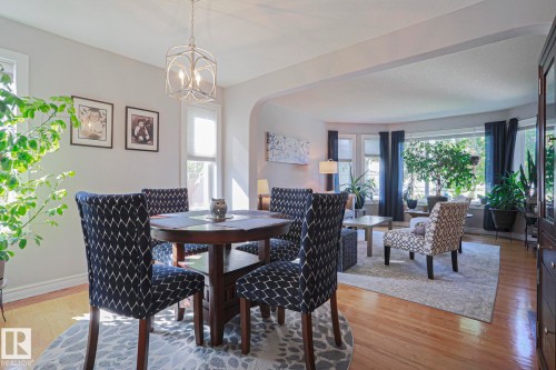 Hardwood flooring throughout, leading to a bay window in the living area - 12 Douziech Close, St. Albert, AB - Indoor Photo Showing Dining Room