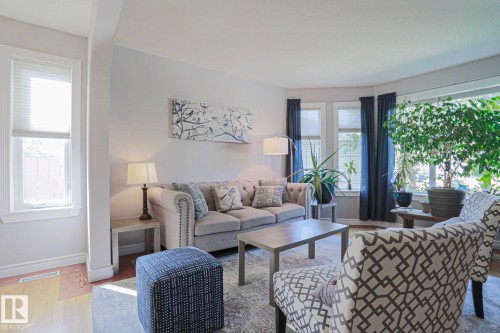 Hardwood flooring, light gray wall color, multiple windows, large bay window, and recessed lighting - 12 Douziech Close, St. Albert, AB - Indoor Photo Showing Living Room