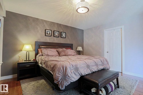 Recessed lighting, wood-finish flooring, and a six-panel door - 12 Douziech Close, St. Albert, AB - Indoor Photo Showing Bedroom