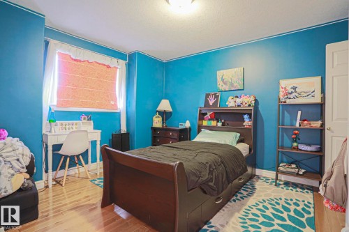 Recessed window with natural light, wood-finish flooring, and a built-in overhead light fixture - 12 Douziech Close, St. Albert, AB - Indoor Photo Showing Bedroom