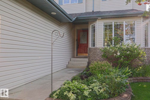 Light-colored siding exterior with a red front door - 12 Douziech Close, St. Albert, AB - Outdoor