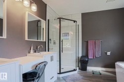 White vanity with integrated sink, rectangular mirrors, and crystal-ornamented light fixtures - 