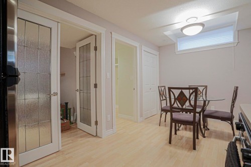 Wood-finish flooring, white trim, recessed window, bi-fold closet, and French doors with textured glass - 12 Douziech Close, St. Albert, AB - Indoor Photo Showing Dining Room