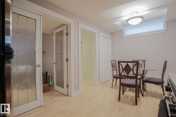Wood-finish flooring, white trim, recessed window, bi-fold closet, and French doors with textured glass - 