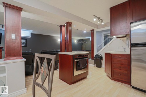 Built-in stainless steel appliances, wood-finish cabinetry, light-toned flooring, recessed lighting, and track lighting fixtures - 12 Douziech Close, St. Albert, AB - Indoor
