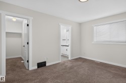 Carpeted room with white trim, a window with blinds, and a built-in closet with shelving - 