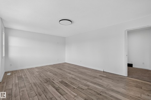 Spacious room featuring light wood-finish flooring, white walls, a single window, and an overhead flush-mount light fixture - 1315 Westerra Drive, Stony Plain, AB - Indoor Photo Showing Other Room