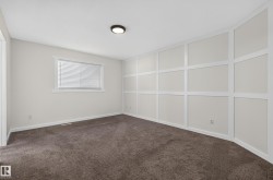 Textured carpeting, board and batten wall accent, window with blinds, recessed lighting fixture - 